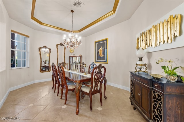 dining area featuring a raised ceiling, crown molding, and a notable chandelier