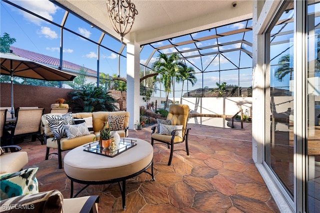 view of patio featuring outdoor lounge area and glass enclosure