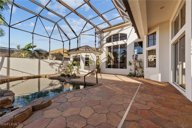 view of patio / terrace featuring glass enclosure and a fenced in pool