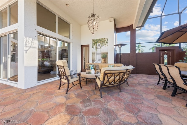 view of patio featuring an outdoor hangout area and glass enclosure