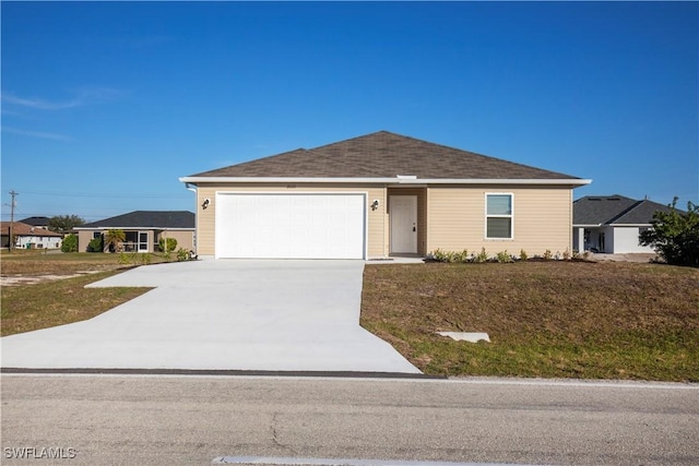 ranch-style house featuring a garage and a front lawn