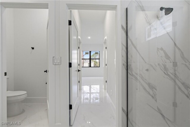 bathroom with an enclosed shower and toilet