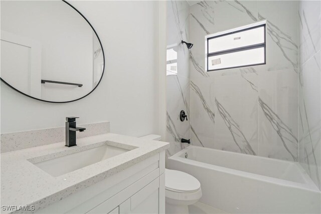 full bathroom featuring toilet, vanity, and tiled shower / bath combo