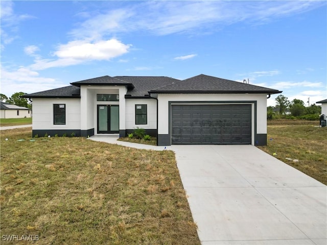 view of front of home with a front yard and a garage