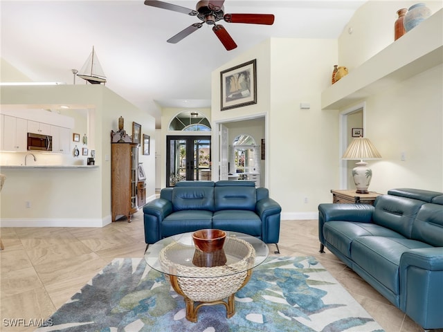 living room featuring ceiling fan and french doors