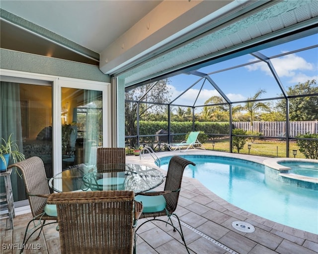 view of pool featuring an in ground hot tub, a lanai, and a patio area