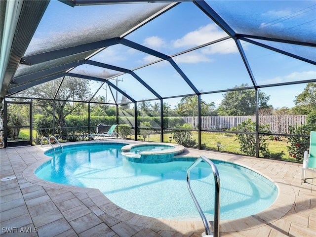 view of pool featuring a lanai, a patio, and an in ground hot tub