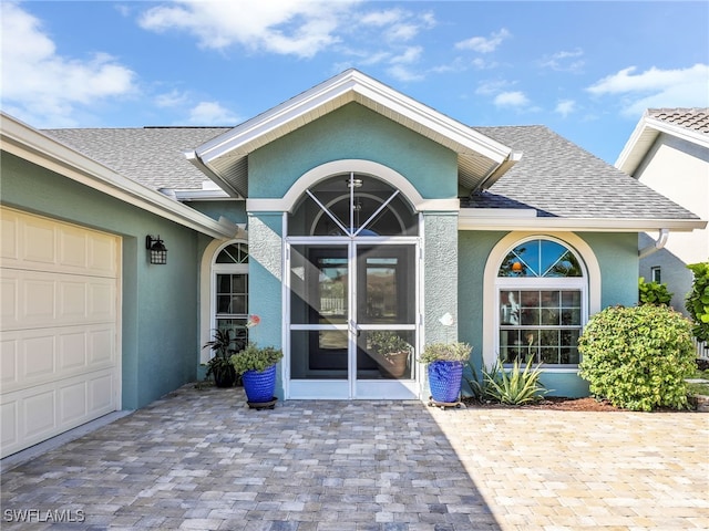 doorway to property with a garage