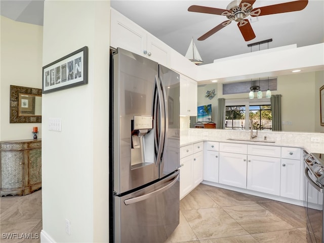 kitchen with kitchen peninsula, stainless steel appliances, ceiling fan, sink, and white cabinets