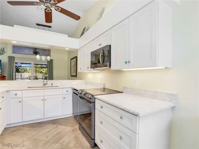 kitchen featuring appliances with stainless steel finishes, ceiling fan, sink, light tile patterned floors, and white cabinets