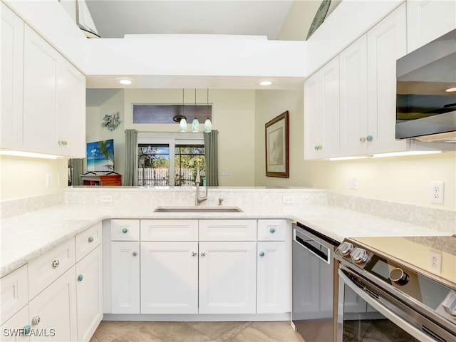 kitchen with white cabinets, sink, light tile patterned flooring, kitchen peninsula, and stainless steel appliances