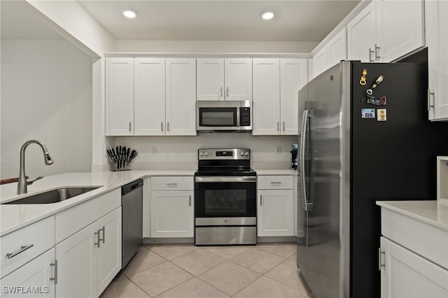 kitchen featuring white cabinets, light tile patterned floors, sink, and appliances with stainless steel finishes