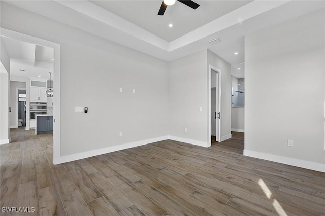 empty room with hardwood / wood-style flooring and ceiling fan