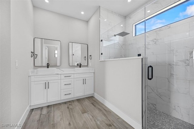 bathroom featuring vanity, a shower with shower door, and hardwood / wood-style flooring