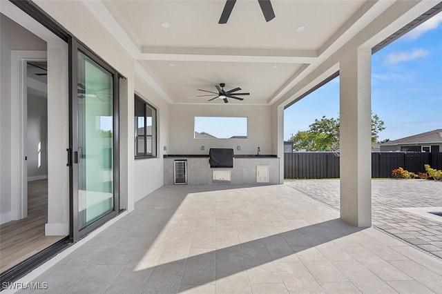 view of patio with ceiling fan and area for grilling