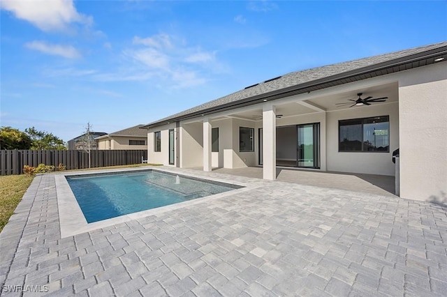 view of swimming pool with ceiling fan and a patio