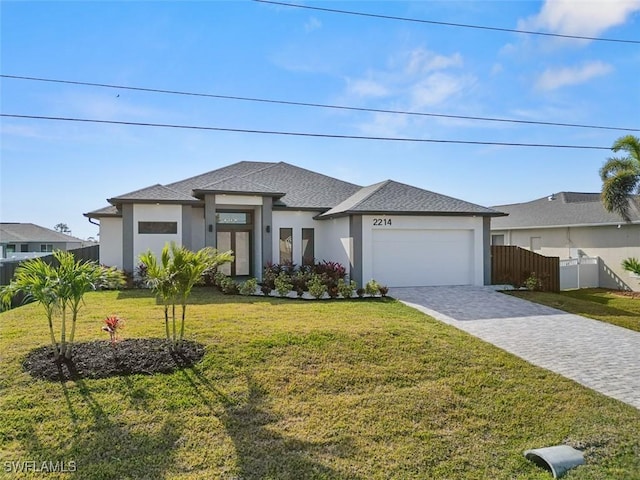 view of front of property featuring a front yard and a garage