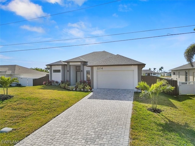 view of front of property featuring a front yard and a garage