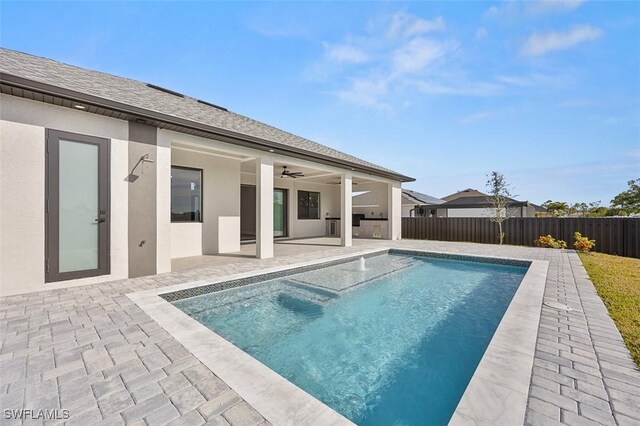 view of swimming pool featuring a patio area and ceiling fan