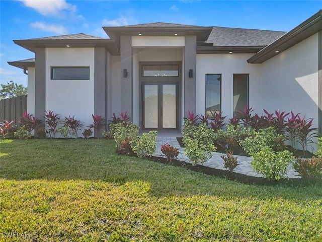 property entrance with a lawn