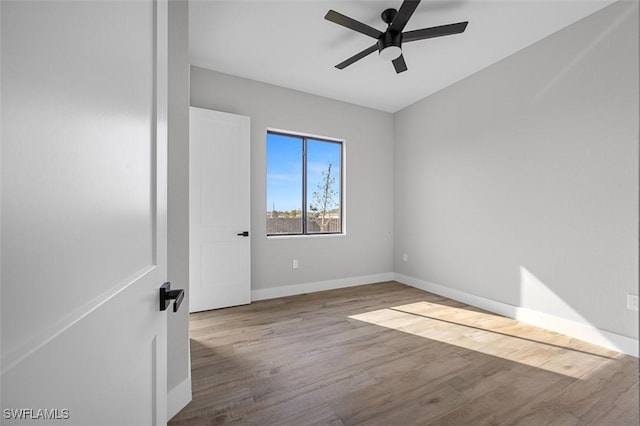 spare room featuring ceiling fan and light hardwood / wood-style flooring