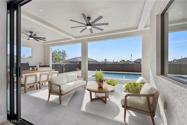 sunroom with beamed ceiling and ceiling fan