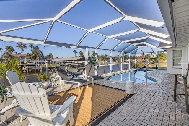 view of pool featuring a patio, a water view, and glass enclosure