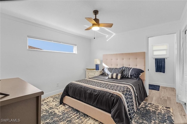 bedroom with ceiling fan, ornamental molding, and light wood-type flooring