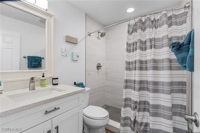 bathroom with a shower with curtain, vanity, and toilet