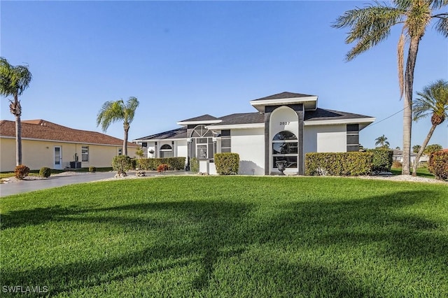 ranch-style home featuring a front yard