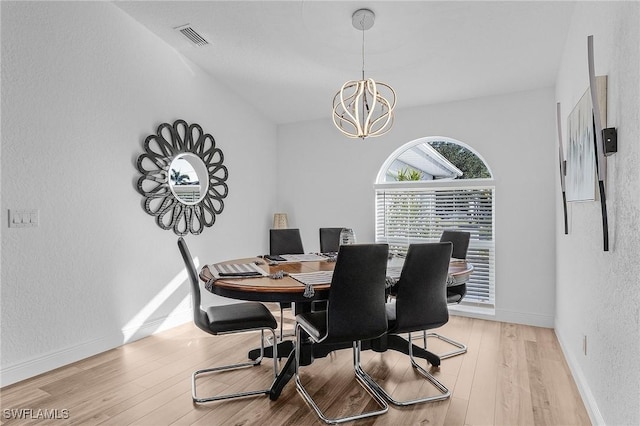 dining room featuring an inviting chandelier and light wood-type flooring