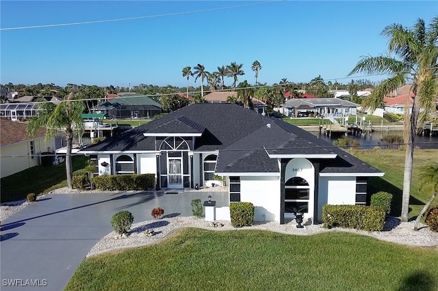 view of front of home featuring a front lawn and a water view