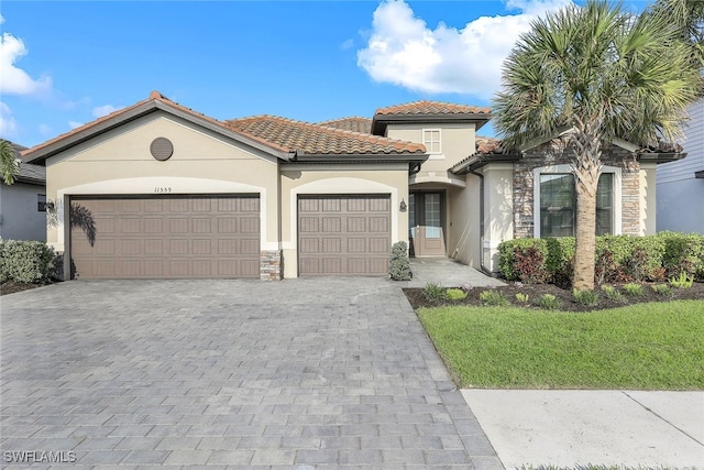 mediterranean / spanish-style home with a garage and a front yard