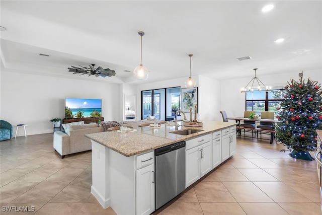 kitchen featuring light stone countertops, white cabinets, dishwasher, sink, and a kitchen island with sink