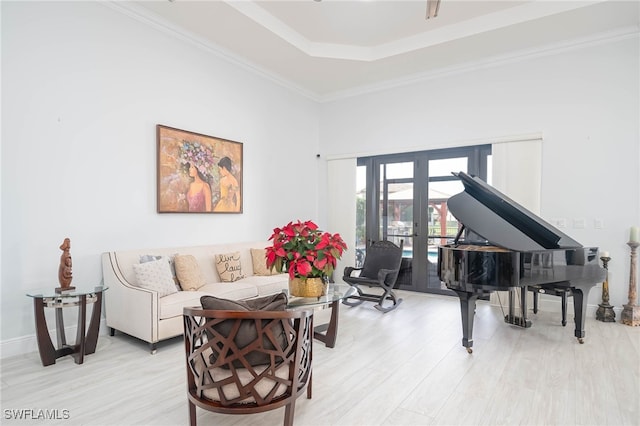 sitting room featuring light hardwood / wood-style flooring, french doors, and ornamental molding