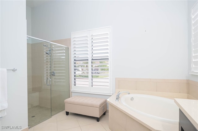 bathroom with tile patterned flooring, vanity, and independent shower and bath