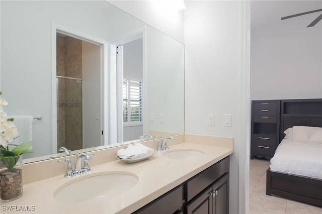 bathroom featuring tile patterned flooring, vanity, a shower with door, and ceiling fan