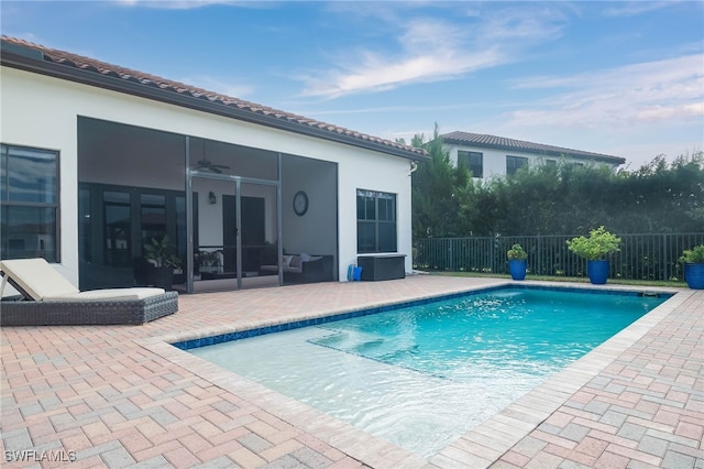 view of pool featuring a patio area, ceiling fan, and a sunroom