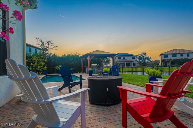 patio terrace at dusk with a gazebo, a fenced in pool, and central air condition unit