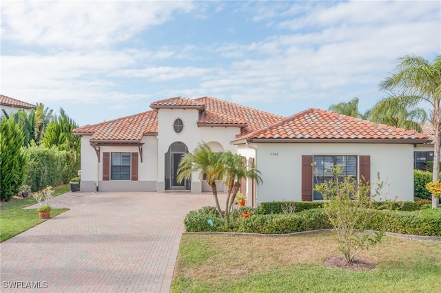 mediterranean / spanish-style house featuring a front lawn