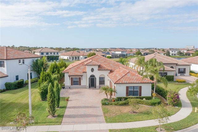 mediterranean / spanish home with a front yard