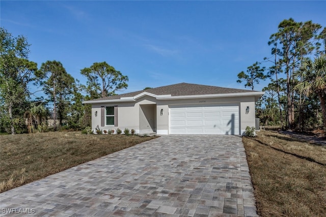 view of front of property with a garage and a front lawn