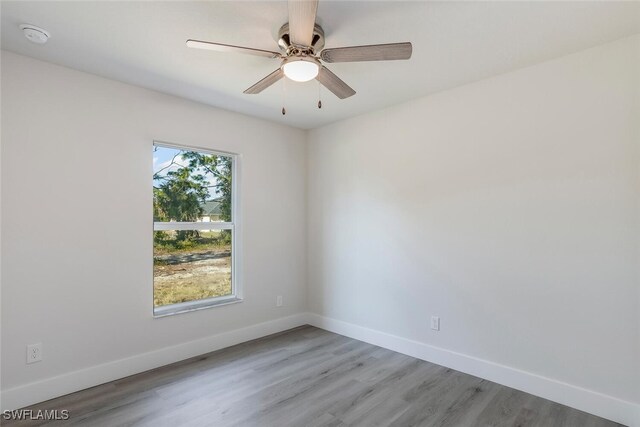 spare room with light wood-type flooring and ceiling fan