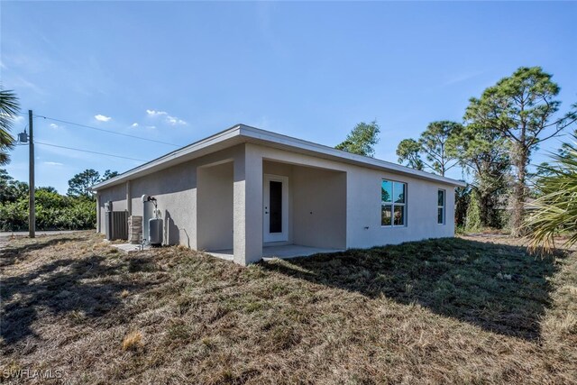 rear view of house with a yard and a patio