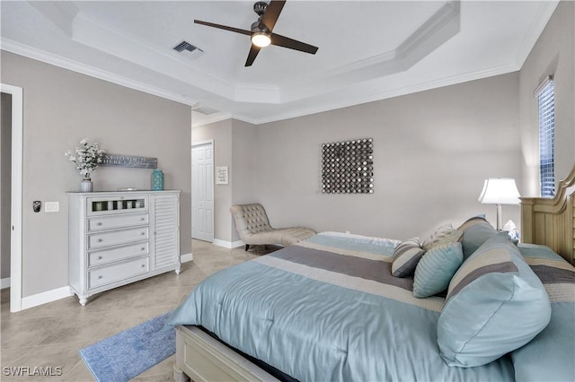 bedroom with a tray ceiling, ceiling fan, a closet, and ornamental molding