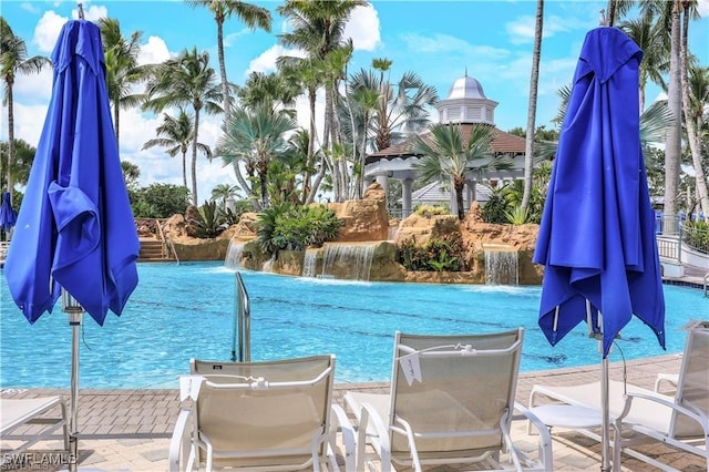 view of swimming pool with pool water feature