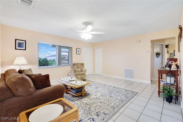 tiled living room with ceiling fan