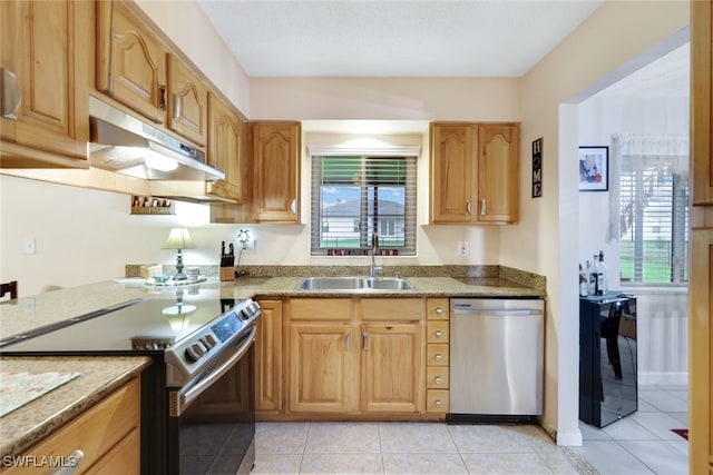 kitchen featuring light tile patterned flooring, stainless steel appliances, plenty of natural light, and sink