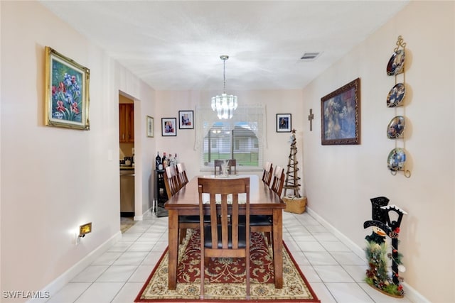 tiled dining space featuring an inviting chandelier