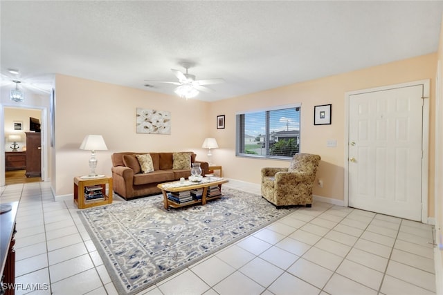 tiled living room featuring a textured ceiling and ceiling fan